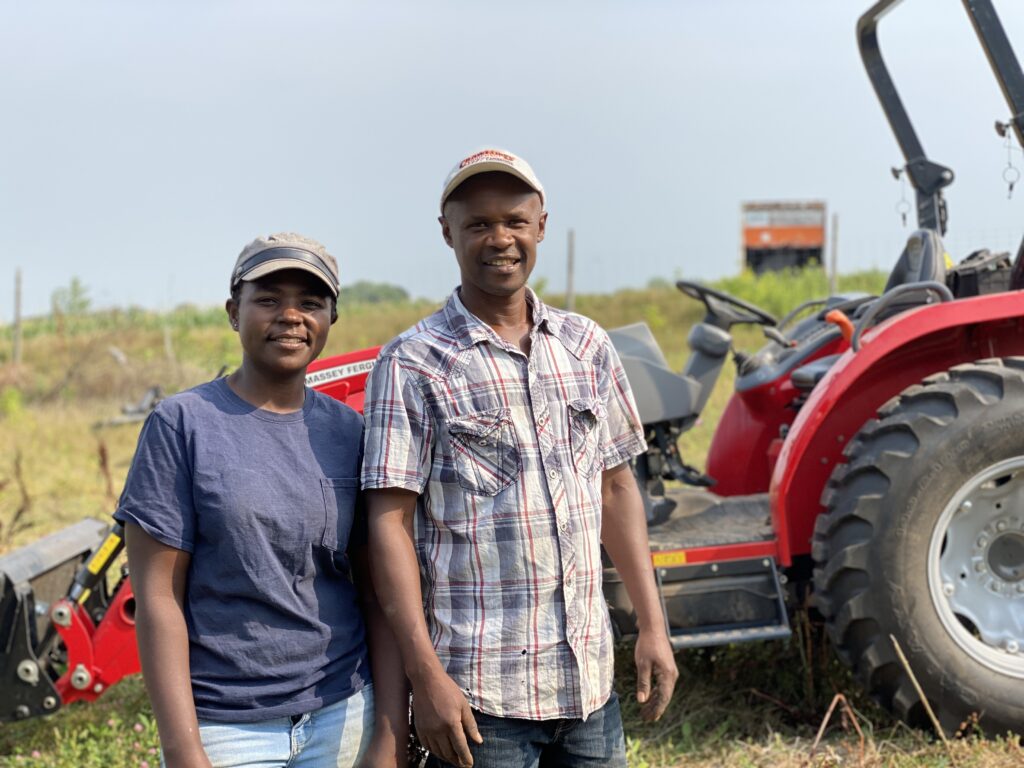 Lonah and Moses Stand by New Tractor