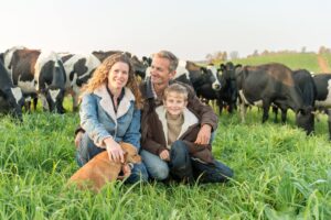 Family In a Field With Cows